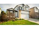 Charming two-story home featuring a well-kept lawn, bay window, and a two-car garage at 9950 Sydney Ln, Highlands Ranch, CO 80130