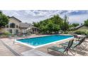 Relaxing community pool area with lounge chairs, tables, and lush landscaping at 8671 E Dry Creek Rd # 721, Englewood, CO 80112