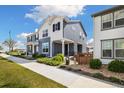 Charming home with a blue and white facade, landscaped walkway, and well-maintained lawn at 8586 Holman Ct # A, Arvada, CO 80005