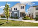 Two-story home showcasing a blue and white exterior with a well-manicured lawn and lush landscaping at 8586 Holman Ct # A, Arvada, CO 80005