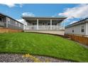 Lush backyard with manicured lawn and a covered deck, perfect for outdoor entertaining at 1148 Sunlit Dr, Castle Rock, CO 80109