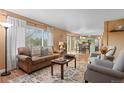 Comfortable living room with stylish furnishings, large window, and seamless flow to the kitchen at 2085 E 127Th Pl, Thornton, CO 80241