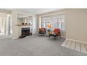 Bright living room featuring fireplace, neutral carpet, and ample natural light at 10212 W 80Th Dr # C, Arvada, CO 80005