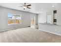 Bright living room with a ceiling fan, a view to the backyard, and an open-concept layout at 2164 Alyssa St, Fort Lupton, CO 80621