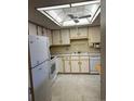 Bright kitchen featuring white appliances and cabinets at 13601 E Marina Dr # 305, Aurora, CO 80014