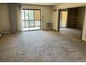 Spacious living room with carpet, access to balcony, and potential for customization at 13601 E Marina Dr # 305, Aurora, CO 80014