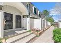 Charming townhome with a welcoming front entrance, walkway, and quaint flower bed at 1350 S Idalia St # G, Aurora, CO 80017