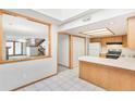Bright kitchen with pass-through to the living room and a view of the wood staircase at 1350 S Idalia St # G, Aurora, CO 80017