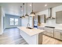 Bright kitchen with a large island, stainless steel appliances, and pendant lighting at 22097 E Rockinghorse Pkwy, Aurora, CO 80016