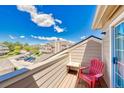 Relax on the balcony with views of the parking area, surrounding buildings, and mountain vistas at 4760 S Wadsworth Blvd # 302, Littleton, CO 80123