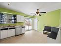 Bright kitchen with white cabinets, stainless steel appliances and breakfast nook at 2402 S Lewiston St, Aurora, CO 80013