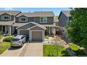 Inviting exterior view showcasing the home's curb appeal, with a driveway and well-manicured lawn at 11062 Gaylord St, Northglenn, CO 80233