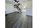 Living room with gray vinyl flooring, a fireplace, and a staircase at 17437 E Rice Cir # B, Aurora, CO 80015