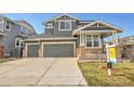 Attractive two-story house features a three-car garage, gray facade, and well-kept lawn at 11845 Mobile St, Commerce City, CO 80022