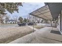 Covered front porch with seating and a view of the street at 2391 Kingston St, Aurora, CO 80010