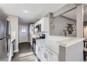 Well-lit kitchen featuring white cabinetry and stainless steel appliances at 2391 Kingston St, Aurora, CO 80010