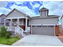 Charming gray two-story home with a covered front porch and two car garage at 9227 Salida St, Commerce City, CO 80022