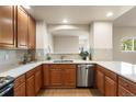 Well-lit kitchen featuring stainless steel appliances, tile backsplash, and a functional layout at 6202 Kilmer Loop # 202, Golden, CO 80403