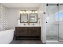Elegant bathroom with double vanity, modern fixtures, and a separate glass-enclosed shower at 1931 Foothills Rd, Golden, CO 80401