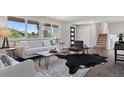 Bright living room with large windows, modern furniture, and stylish hardwood floors at 1931 Foothills Rd, Golden, CO 80401