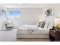 Serene main bedroom featuring plush carpeting, a cozy chair, and ample natural light at 1931 Foothills Rd, Golden, CO 80401