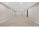 Large, open carpeted basement area with neutral walls and recessed lighting offers versatile living space at 6359 Brooks Dr, Arvada, CO 80004