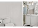 Bright bathroom features a modern vanity, glass enclosed shower, and a neutral color scheme at 6359 Brooks Dr, Arvada, CO 80004