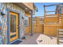 Cozy deck area with beautiful multi-tone stone wall at 220 Wark Ave, Berthoud, CO 80513
