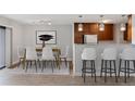 Bright dining room area featuring a modern light fixture and a view of the balcony at 480 S Marion Pkwy # 802, Denver, CO 80209