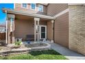 Inviting front entrance with a cozy porch and well-manicured flower bed at 19681 E 59Th Pl, Aurora, CO 80019