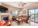 Inviting living room with a fireplace, comfortable seating, and access to a balcony at 1044 Rockhurst Dr # 208, Highlands Ranch, CO 80129