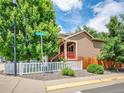 Cozy home with a red-railed porch and well-maintained yard, close to Louisiana Ave at 1288 S Beeler Ct, Denver, CO 80247