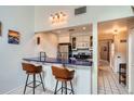 Eat-in kitchen features a breakfast bar with seating, stainless steel appliances, and a sleek countertop at 3260 47Th St # 205A, Boulder, CO 80301
