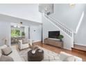 Bright living room with high ceilings and hardwood flooring, open to dining area at 19410 E Ithaca Pl, Aurora, CO 80013