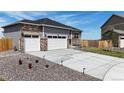 A beautiful home with a long driveway and manicured front lawn at 13488 Wabash St, Thornton, CO 80602