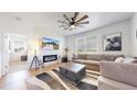 A modern living room design with a cozy fireplace and stylish decor at 13488 Wabash St, Thornton, CO 80602