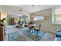 Open-concept living room with a cozy seating area, large windows, and stylish decor at 6292 Kilmer Loop # 201, Golden, CO 80403