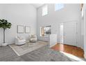 Bright living room with tall ceilings, lots of natural light, and neutral decor at 10933 E 115Th Pl, Commerce City, CO 80640