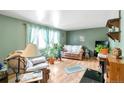 Cozy living room with bright natural light, laminate flooring, comfortable seating, and decorative accents at 6994 W Hinsdale Dr, Littleton, CO 80128