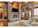 Spacious living room with a stone fireplace and hardwood floors at 4691 Bandera Pl, Parker, CO 80134