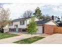 Charming two-story home with a brick facade, attached two car garage, and green lawn at 9380 Raleigh Ct, Westminster, CO 80031