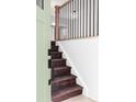 View of the wooden staircase with metal balusters from the entry featuring a wooden railing at 9380 Raleigh Ct, Westminster, CO 80031