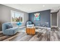 Cozy living room featuring modern decor, comfortable seating, hardwood floors and a window that provides natural light at 1498 S Perry St, Denver, CO 80219