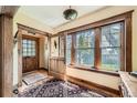 Light-filled foyer features hardwood floors, wood trim, and a charming vintage rug at 171 N Franklin St, Denver, CO 80218
