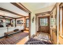 Elegant foyer with hardwood floors, natural wood trim, and views into the living room at 171 N Franklin St, Denver, CO 80218