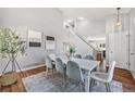 Bright dining room with stylish decor, a modern table setting, and elegant hardwood floors creating an inviting atmosphere at 4252 S Halifax Way, Aurora, CO 80013