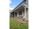 Inviting front porch with rocking chairs, colorful flower pots, and a hanging flower basket at 9963 W Canyon Ave, Littleton, CO 80127