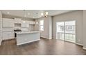 Modern kitchen features white cabinets, stainless appliances, and island with granite countertops at 1898 Westport Ave, Berthoud, CO 80513