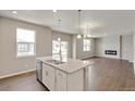 Bright, open kitchen boasts an island with granite countertops and stainless steel appliances at 1898 Westport Ave, Berthoud, CO 80513