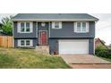 Attractive two-story home showcasing a gray exterior, white trim, and a convenient attached garage at 103 Aurelia St, Palmer Lake, CO 80133